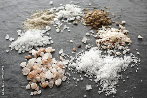 Different types of salt crystals, sea salt, Himalaya coarse salt, fleur de sel, chipotle flingsalt, hickory smoked salt, stone salt and garlic salt photo