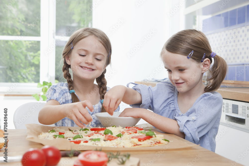 Germany, Munich, Girls preparing food in kitchen Germany, Munich, Girls preparing food in kitchen