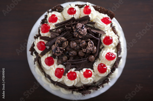 Chocolate cake with cream and cherries, from above.