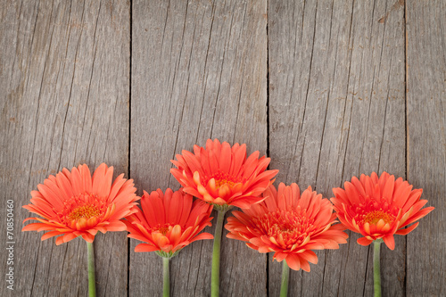 Fototapeta Naklejka Na Ścianę i Meble -  Wooden background with orange gerbera flowers
