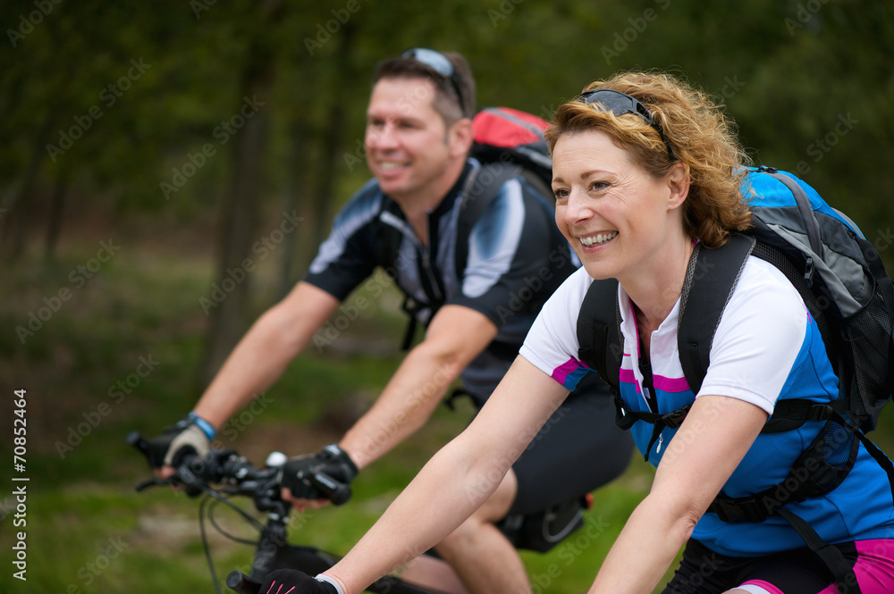 Cheerful couple enjoying a bike ride in nature Cheerful couple enjoying a bike ride in nature