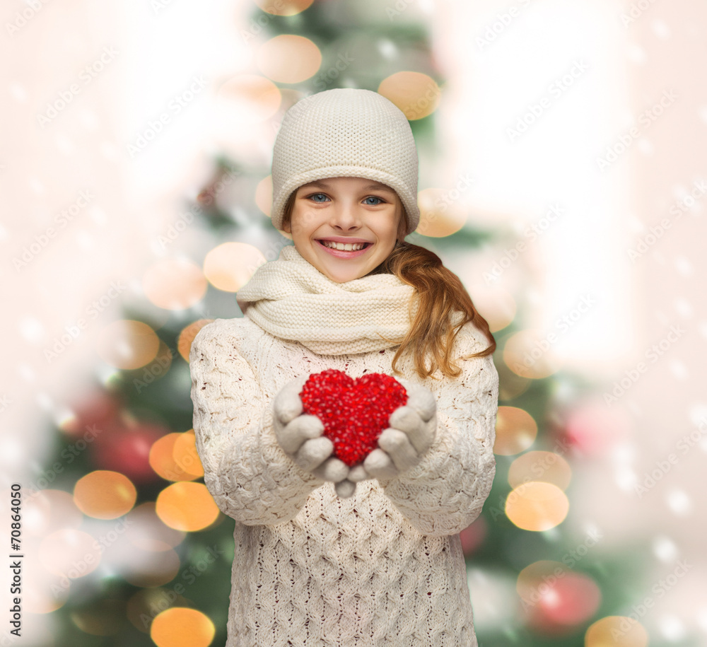 girl in winter clothes with small red heart girl in winter clothes with small red heart