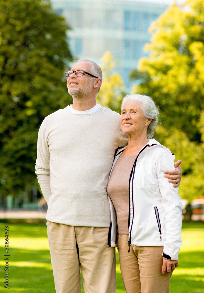senior couple hugging in city park