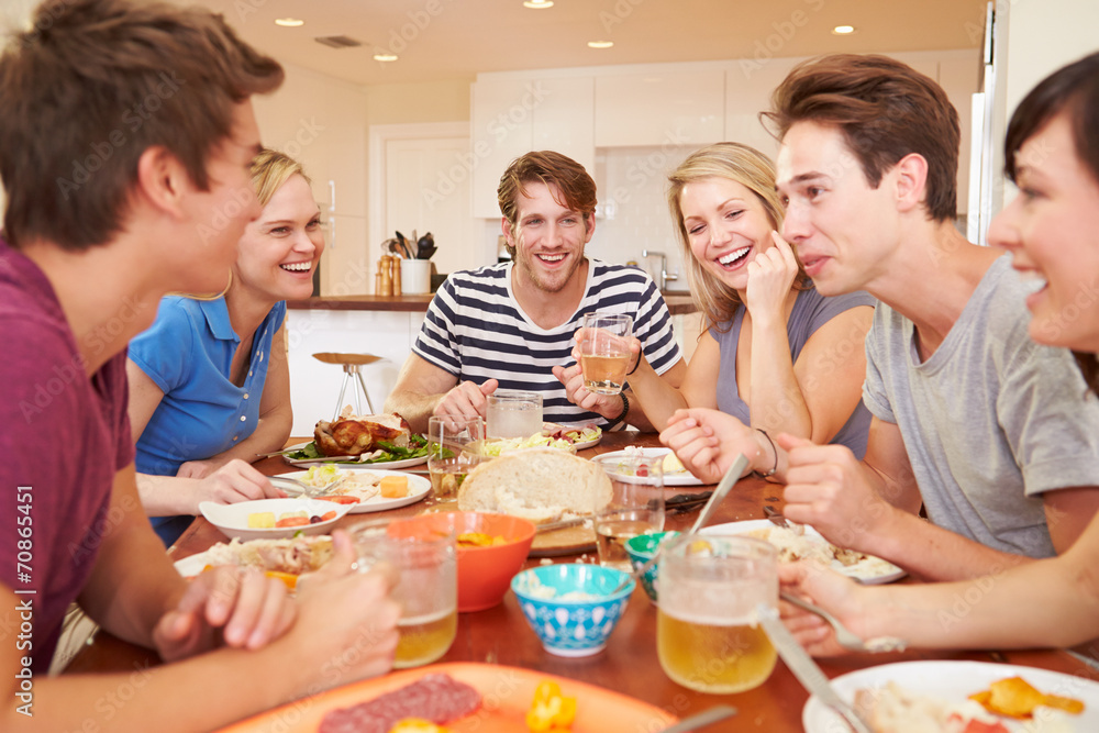 Group Of Young Friends Enjoying Meal At Home Group Of Young Friends Enjoying Meal At Home