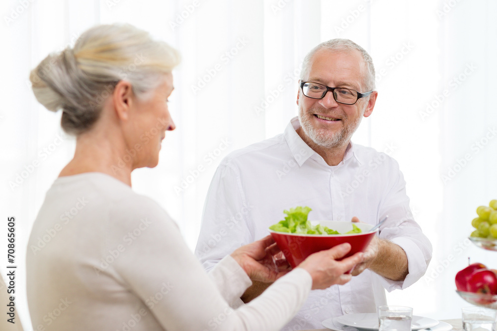 smiling senior couple having dinner at home smiling senior couple having dinner at home