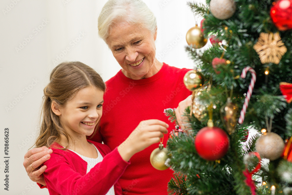 smiling family decorating christmas tree at home smiling family decorating christmas tree at home