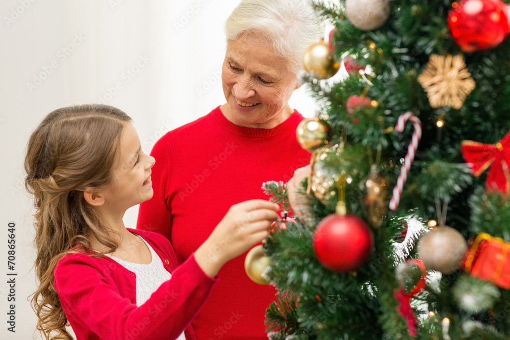 smiling family decorating christmas tree at home smiling family decorating christmas tree at home