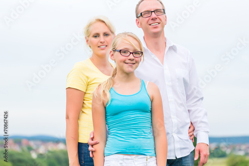 Family standing on grass of lawn or field © Kzenon