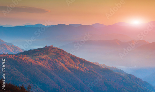 Panorama of autumn mountains in the morning mist