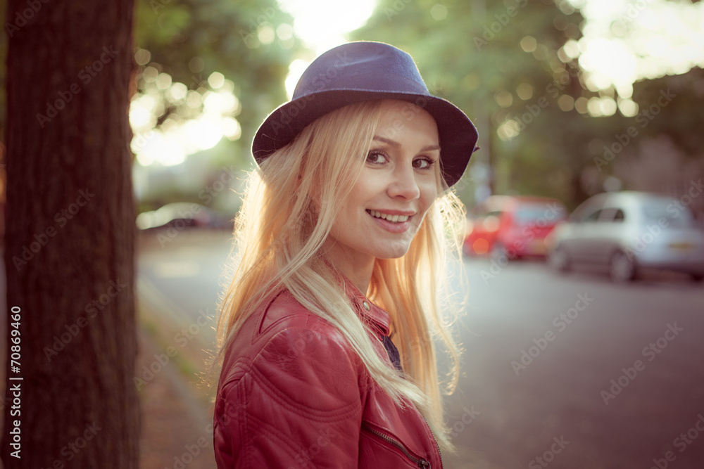 Woman with her long blond hair backlit by the sun