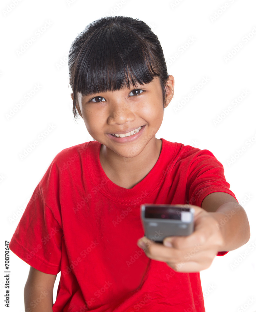 Young Asian girl with television remote control device Young Asian girl with television remote control device