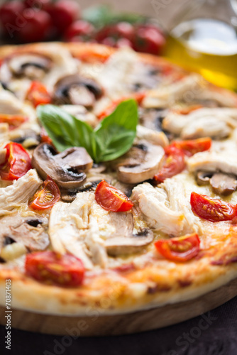 Pizza with chicken, tomato and mushrooms close up