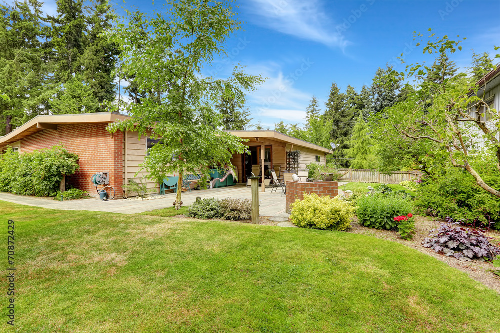 Walkout patio with concrete tile floor and landscape design