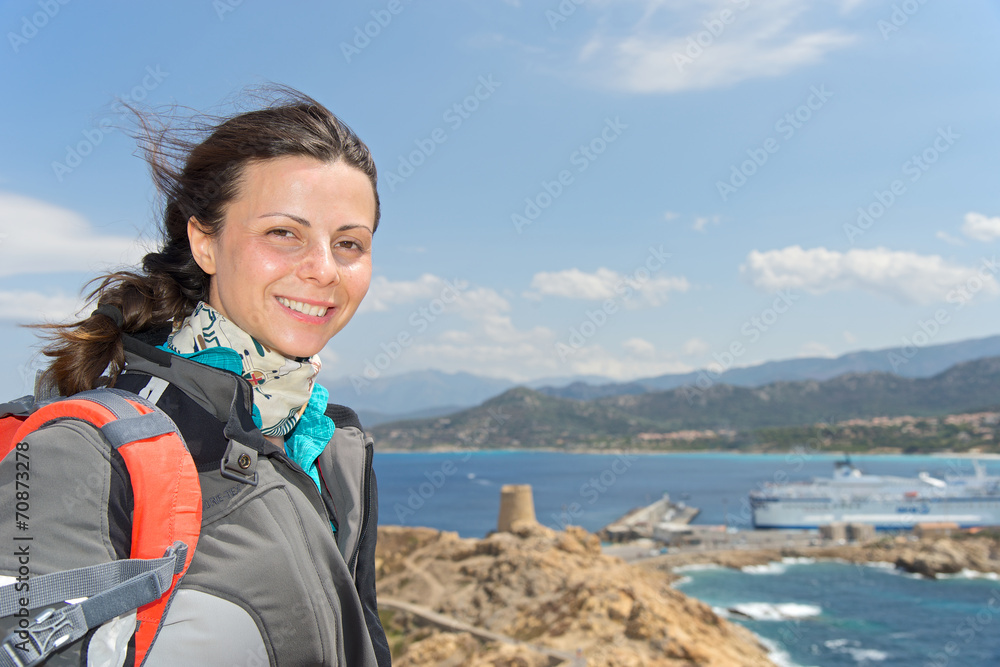 Smiling girl near the tower of L'Ile Rousse, Corsica, France Smiling girl near the tower of L'Ile Rousse, Corsica, France
