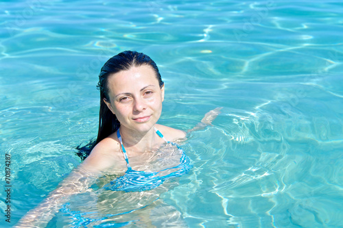 Young woman swimming in a heavenly sea, Saleccia beach Corsica