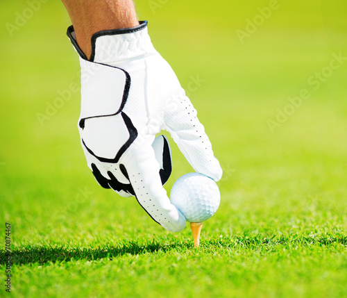 Man Placing Golf Ball on Tee