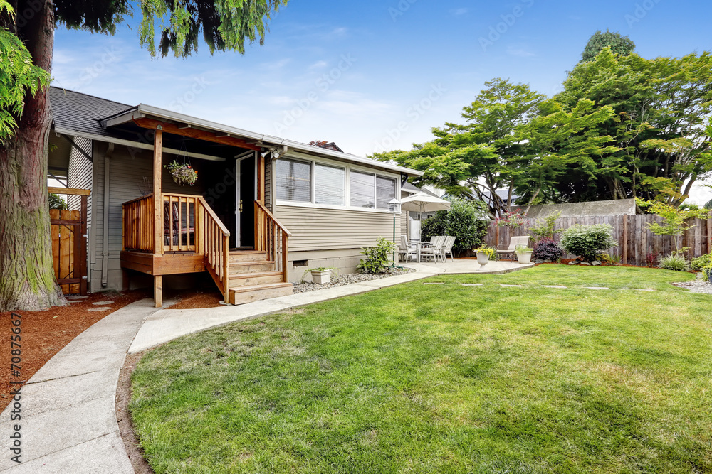 House with small walkout deck to backyrd area