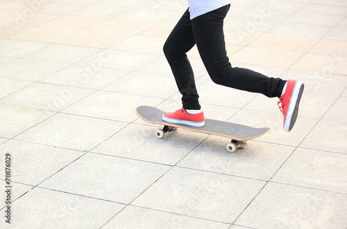  woman legs skateboarding at city