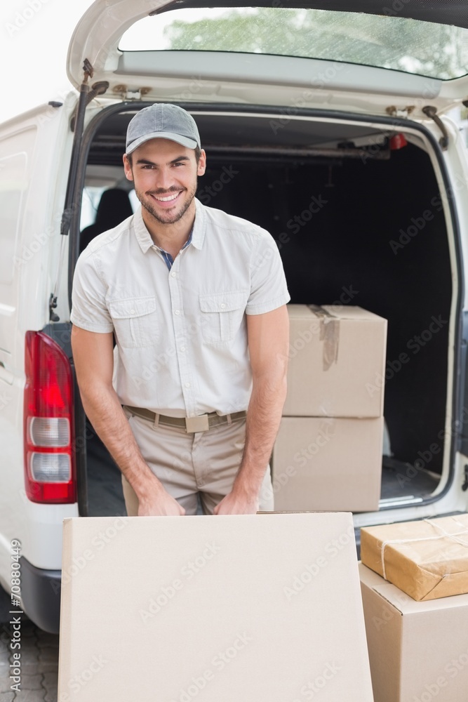 Delivery driver loading his van with boxes Delivery driver loading his van with boxes