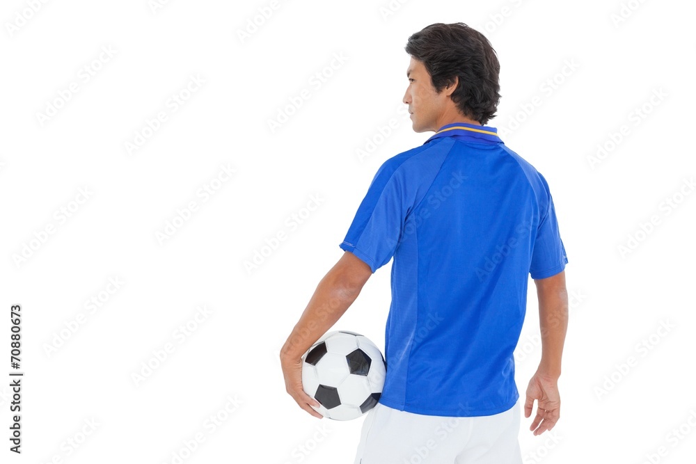 Serious football player over white background