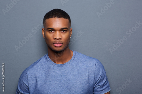 Handsome young black man with serious expression on face