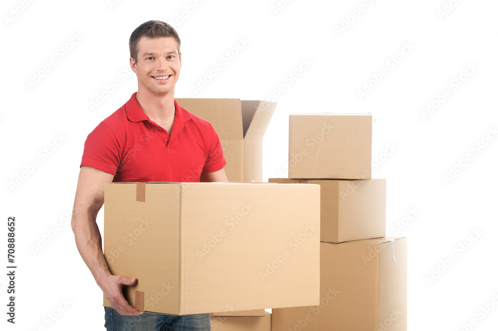 man holding moving box and smiling at camera. man holding moving box and smiling at camera.