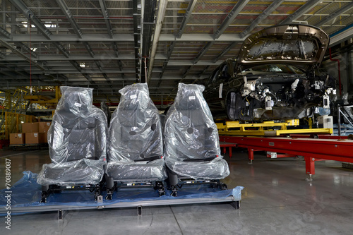 Automobile chairs in packing stand in assembly shop of automobil