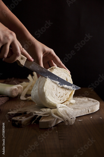 Woman cutting a cabbage