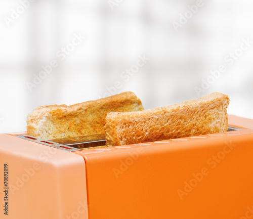Orange toaster with two slices of bread