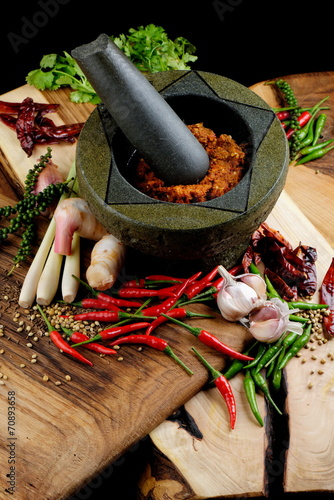 Asian herbs, spices and vegetables with mortar making curry