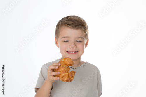 a boy and a croissant