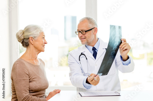 smiling senior woman and doctor meeting