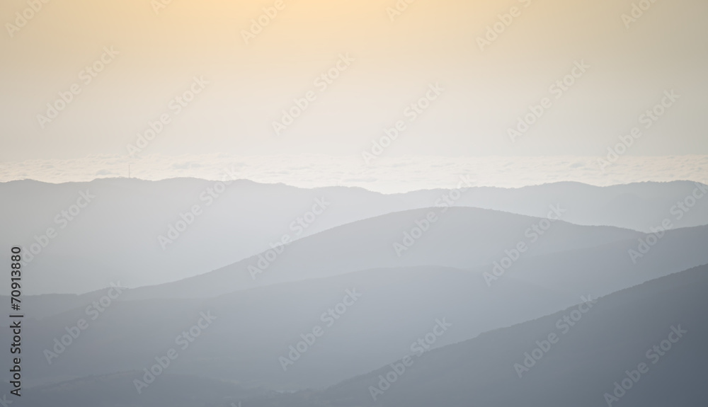 Silhouettes of mountain slopes in the haze