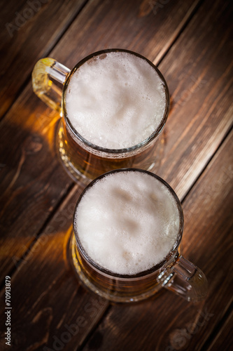 mug of beer on wooden background