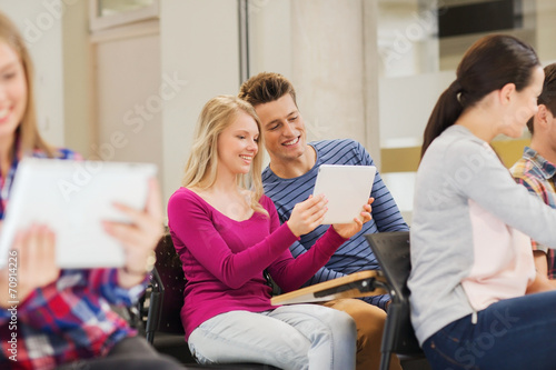 group of smiling students with tablet pc