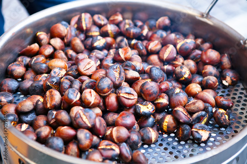 Grilled chestnuts for sale in a market stall