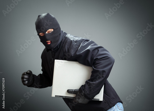 Fotografia Thief stealing laptop computer