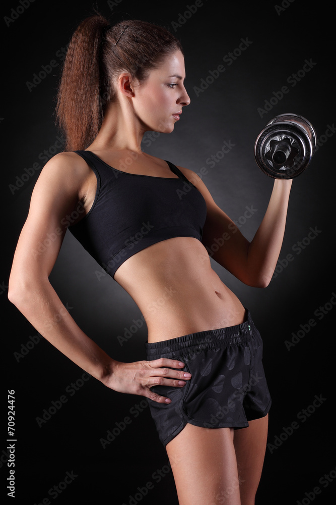 beautiful sporty woman working out with dumbbells beautiful sporty woman working out with dumbbells