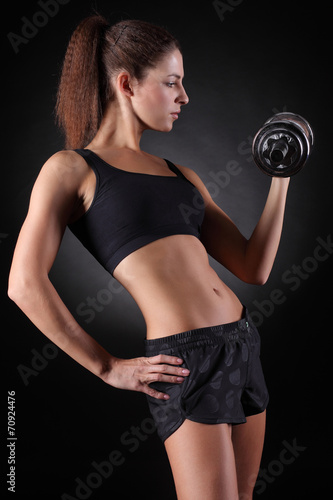 beautiful sporty woman working out with dumbbells