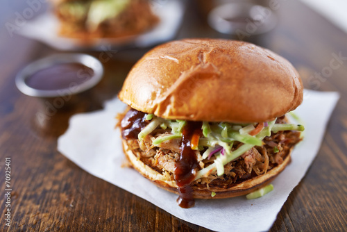 barbecue pulled pork sandwiches with cole slaw on wood table