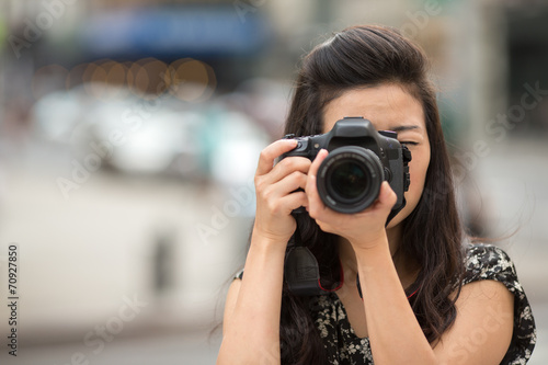 Young Asian Woman taking photo with camera