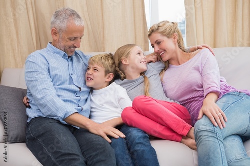 Happy parents with their children on sofa © WavebreakMediaMicro