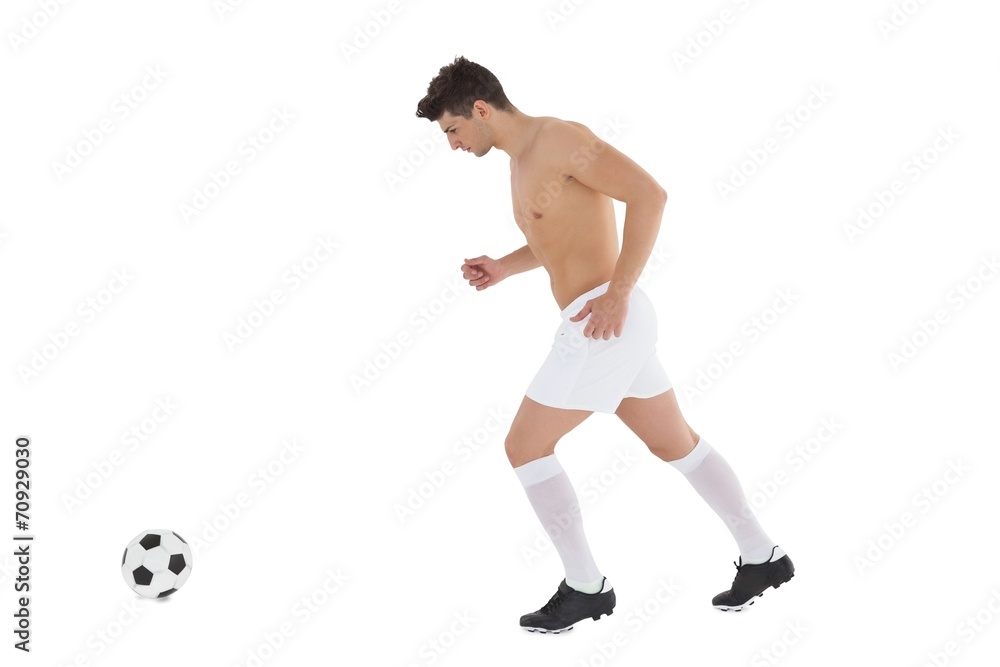 Full length of shirtless football player playing