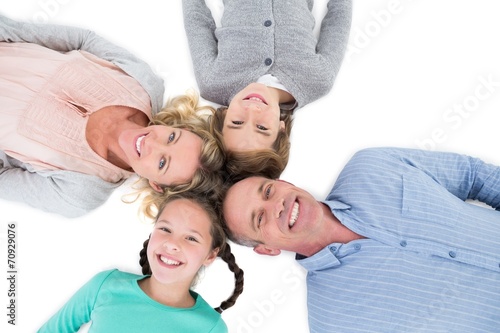 Overhead of smiling family lying together in a circle