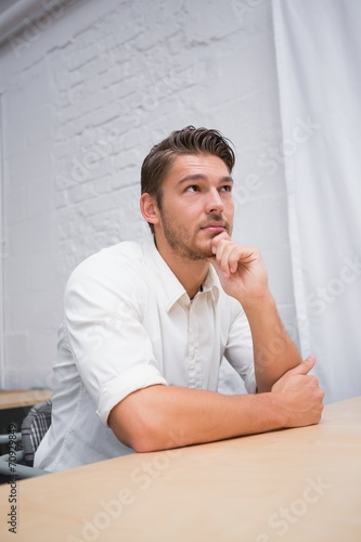 Thoughtful businessman looking away at office