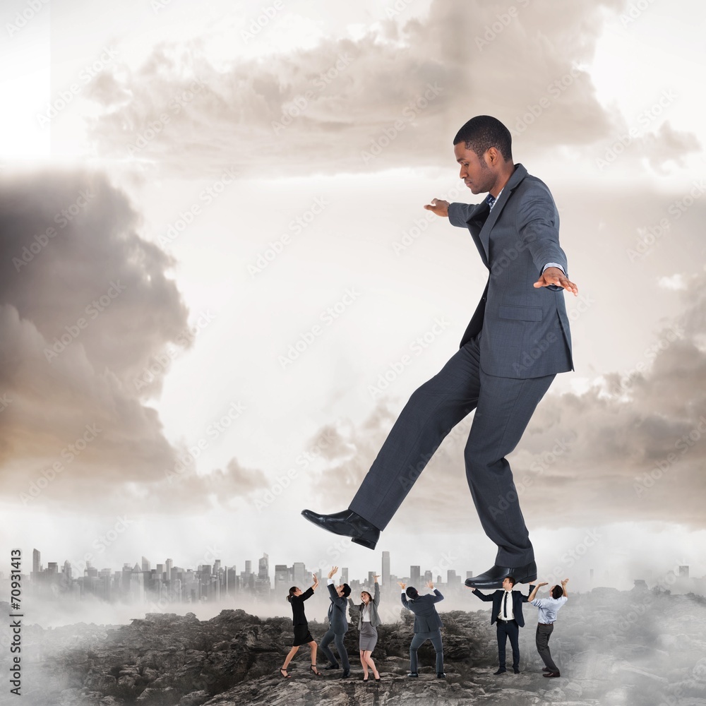 Composite image of business team supporting boss Composite image of business team supporting boss
