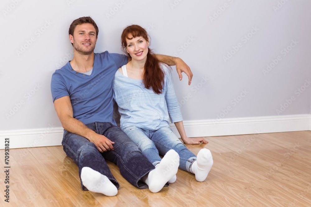 Couple sitting on floor together Couple sitting on floor together