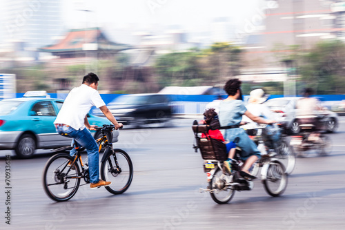 bicycle riders in the city in motion blur