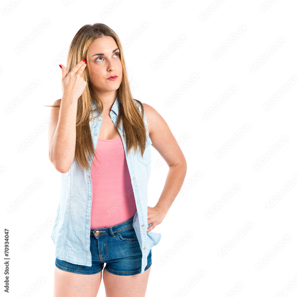 Girl making suicide gesture over white background Girl making suicide gesture over white background