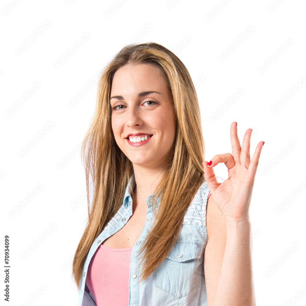 Girl making Ok sign over white background Girl making Ok sign over white background